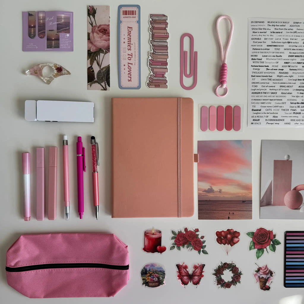 Collection of stationery items including pens, a notebook, and decorative stickers on a white background.