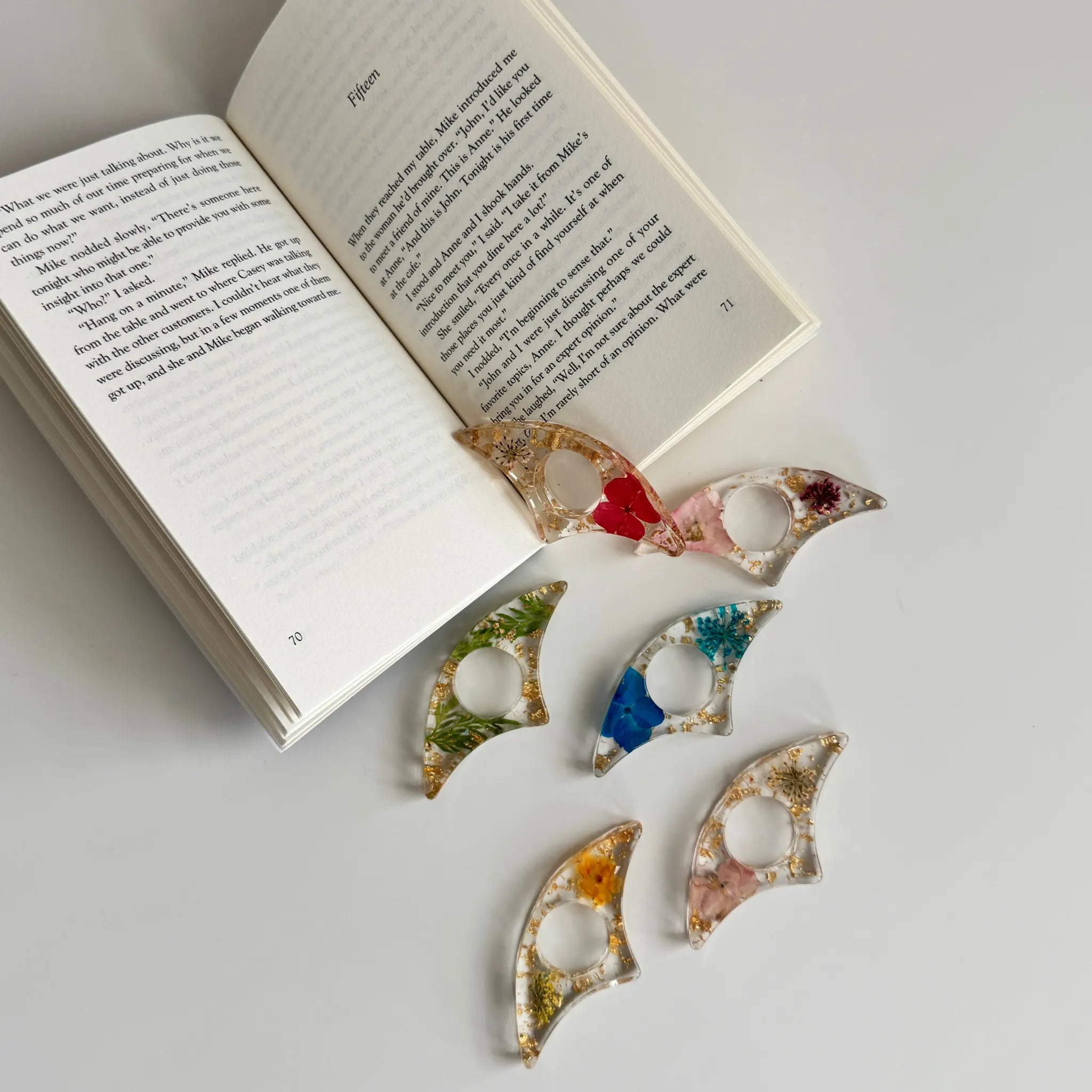 Colorful fish-shaped book holders on an open book
