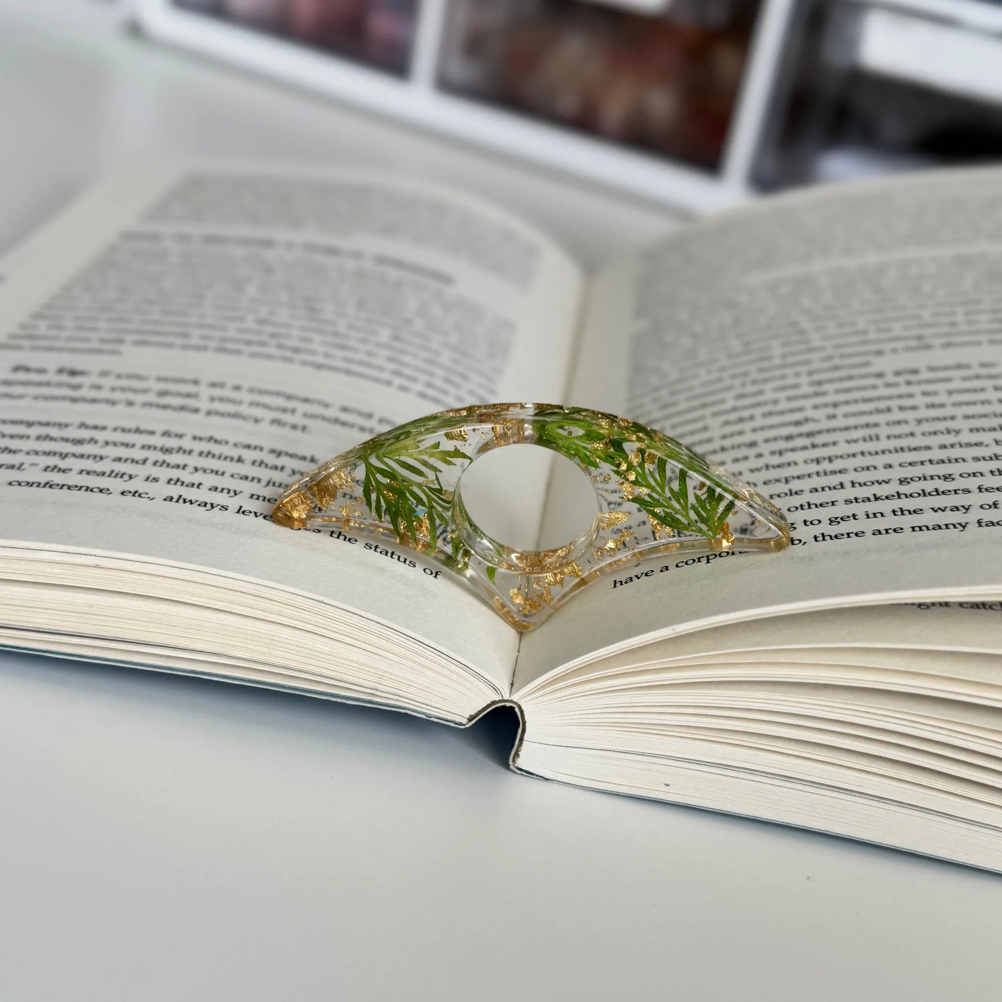 Decorative book holder with red flower on an open book