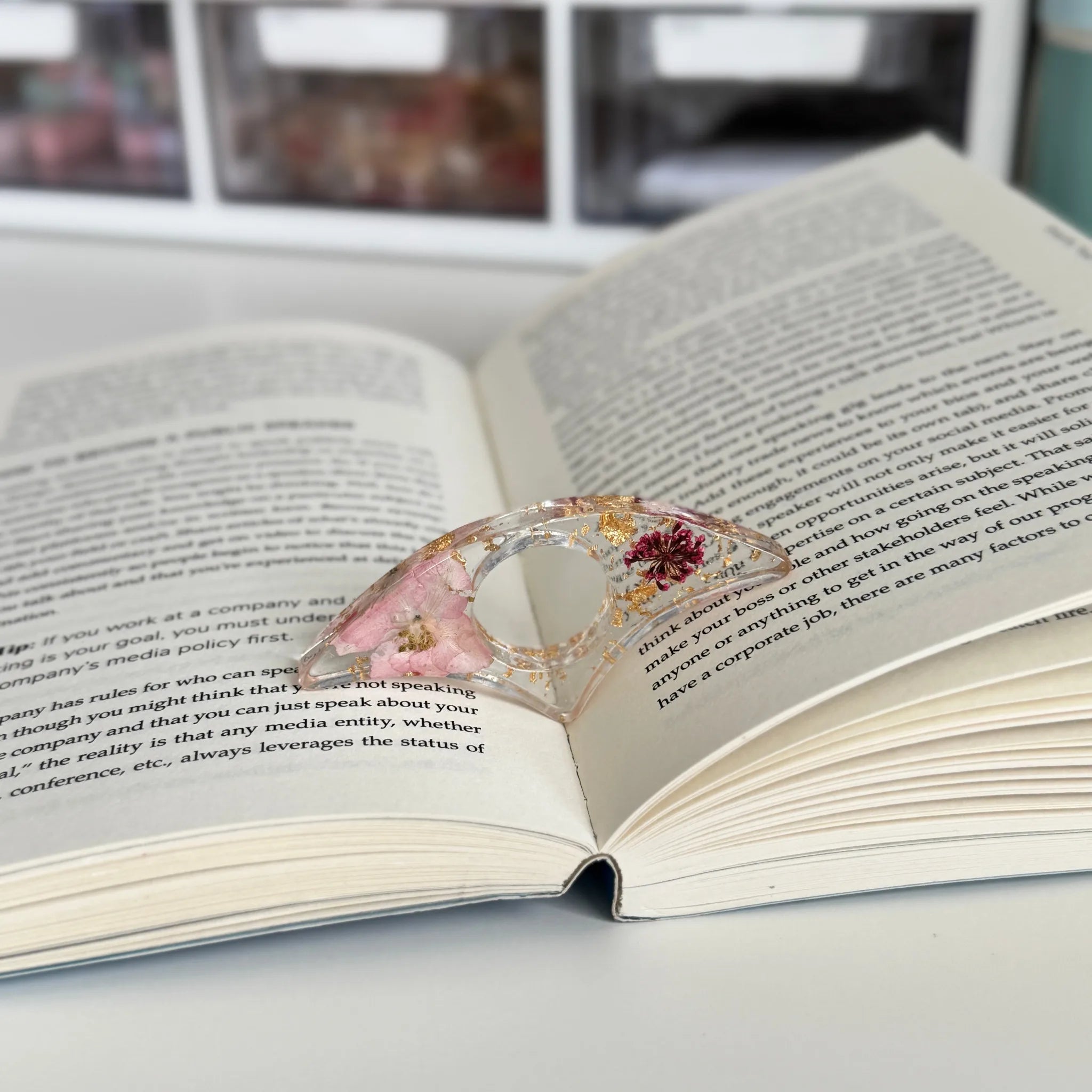 Decorative book holder with red flower on an open book