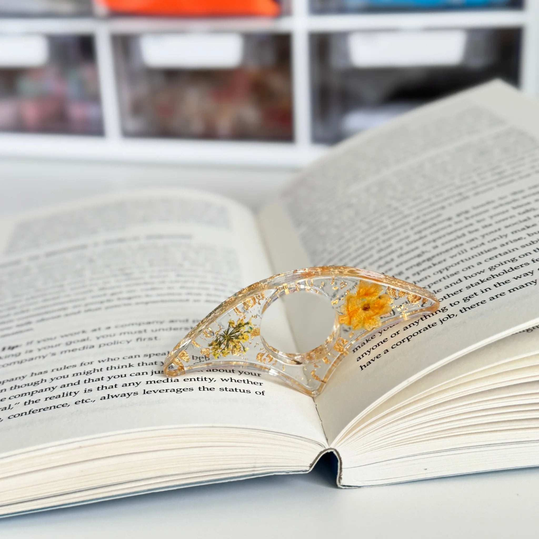 Decorative book holder with red flower on an open book