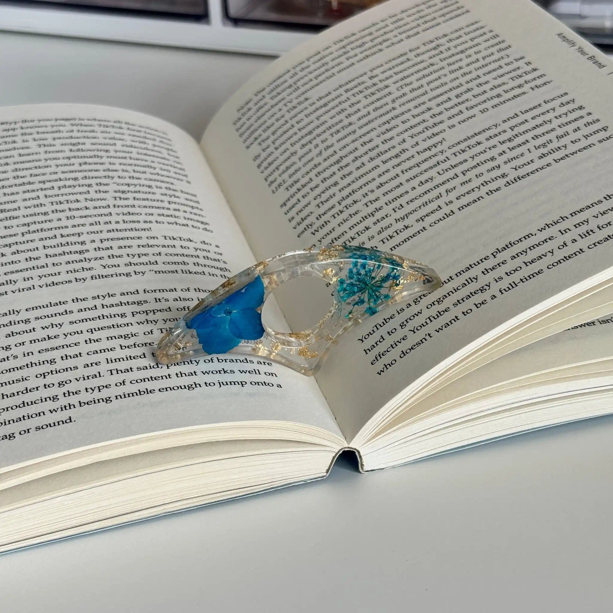 Decorative book holder with red flower on an open book