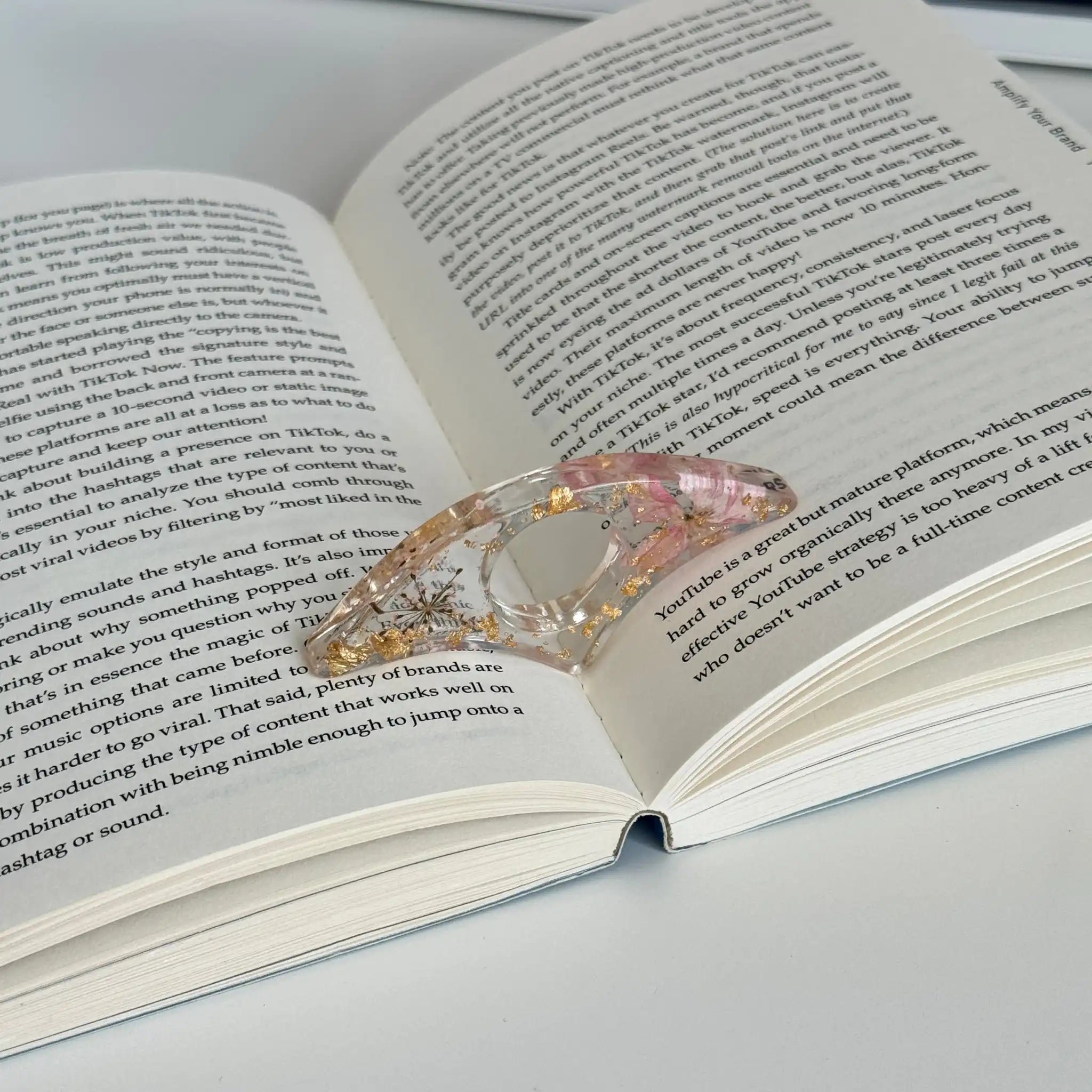 Decorative book holder with red flower on an open book