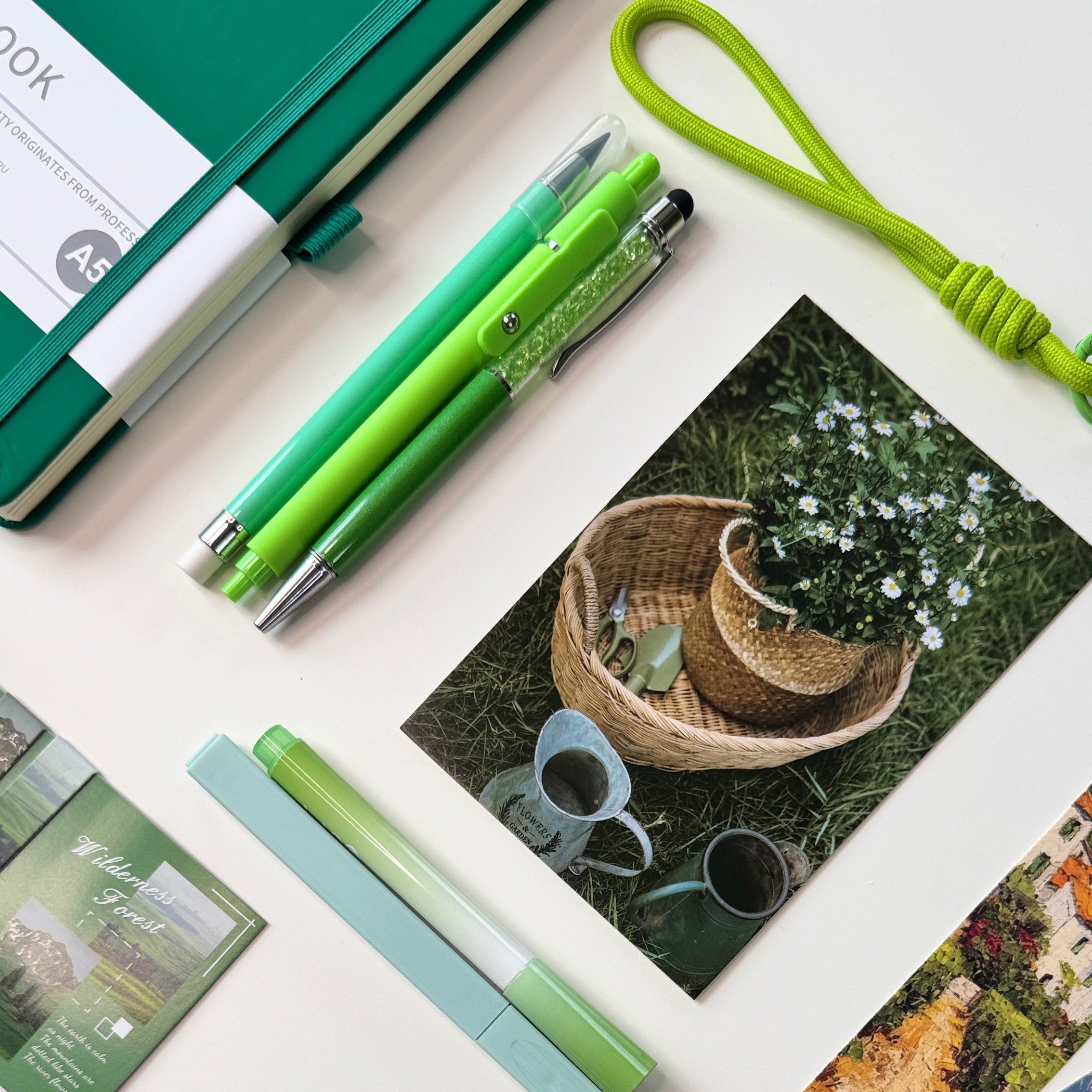 Rooti Signature Bundle including an A5 notebook, pencil case, two pens, pencil, two highlighters, sticky notes, sticky tabs, page holder, metal bookmark, paper bookmarks, magnetic bookmarks, sticker sheet, decorative pin, reading light with three modes, book tracker, key chain, postcard, hair clip, and scrunchie.