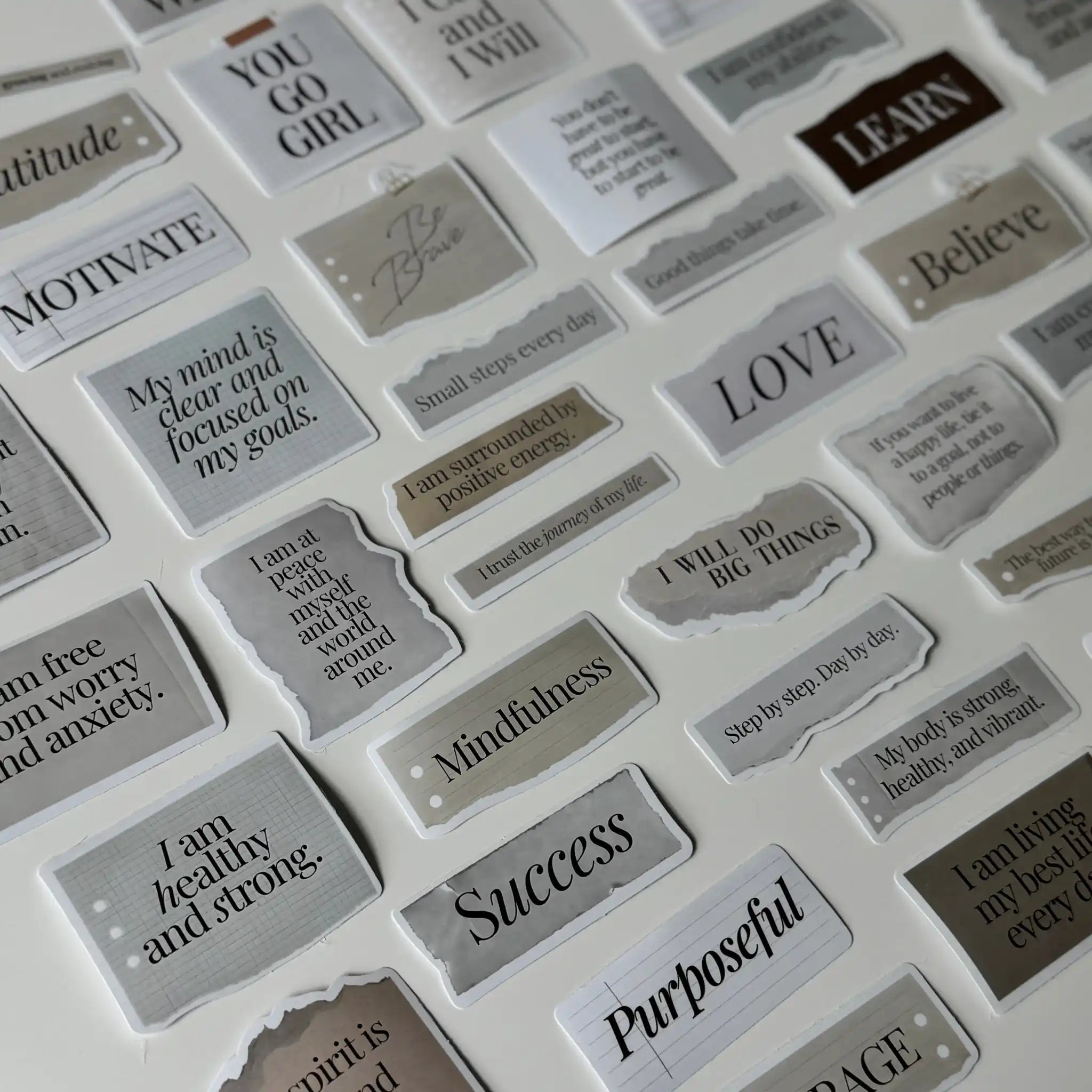 Collection of motivational stickers with various phrases on a white background
