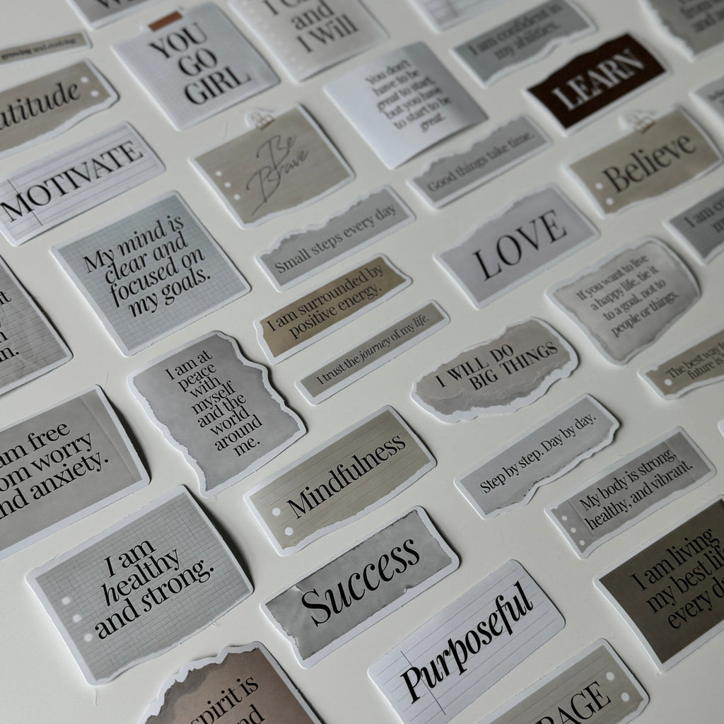 Collection of motivational stickers with various phrases on a white background