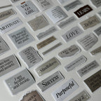 Collection of motivational stickers with various phrases on a white background