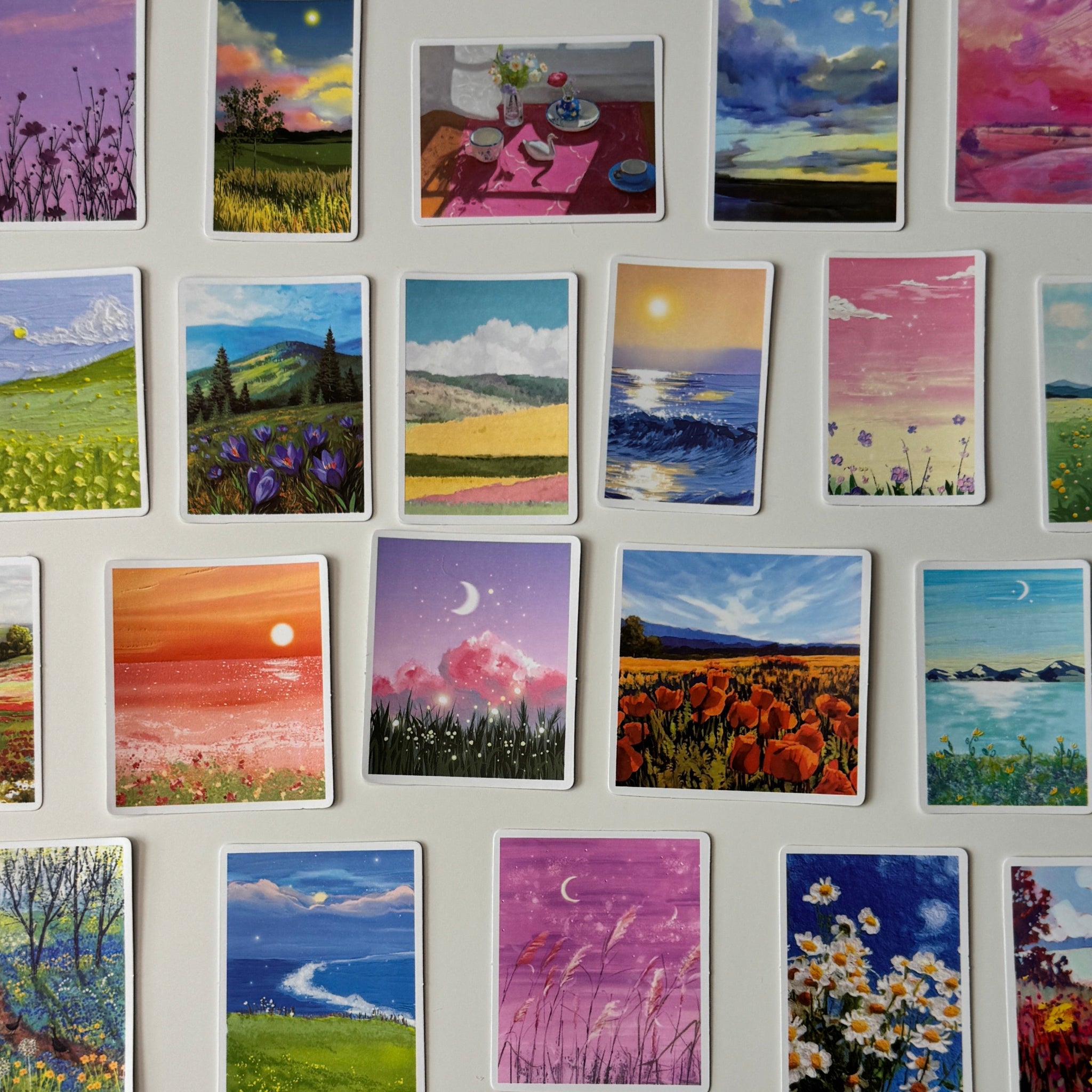 Collection of small landscape paintings on a wall