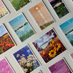 Collection of small painted cards depicting various landscapes and scenes.