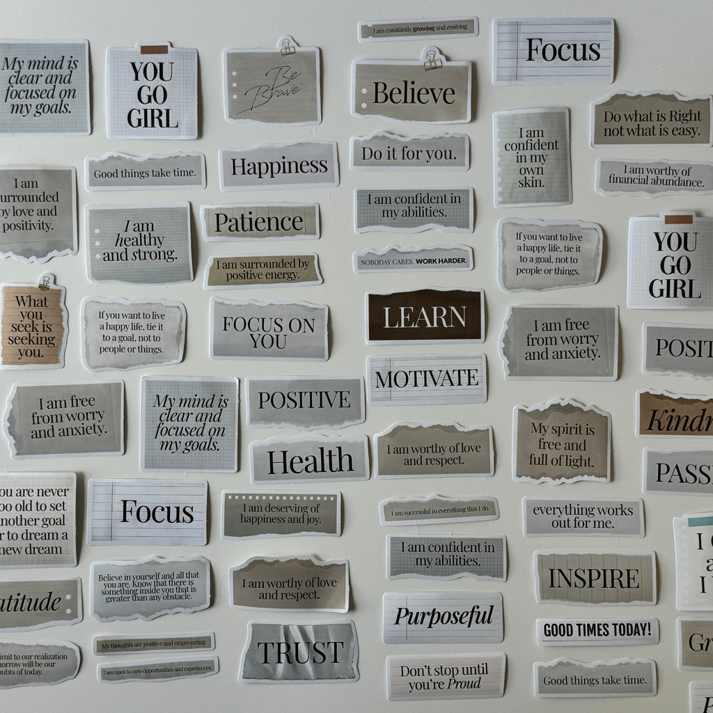 Motivational phrases on small rectangular cards attached to a wall.