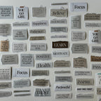 Motivational phrases on small rectangular cards attached to a wall.