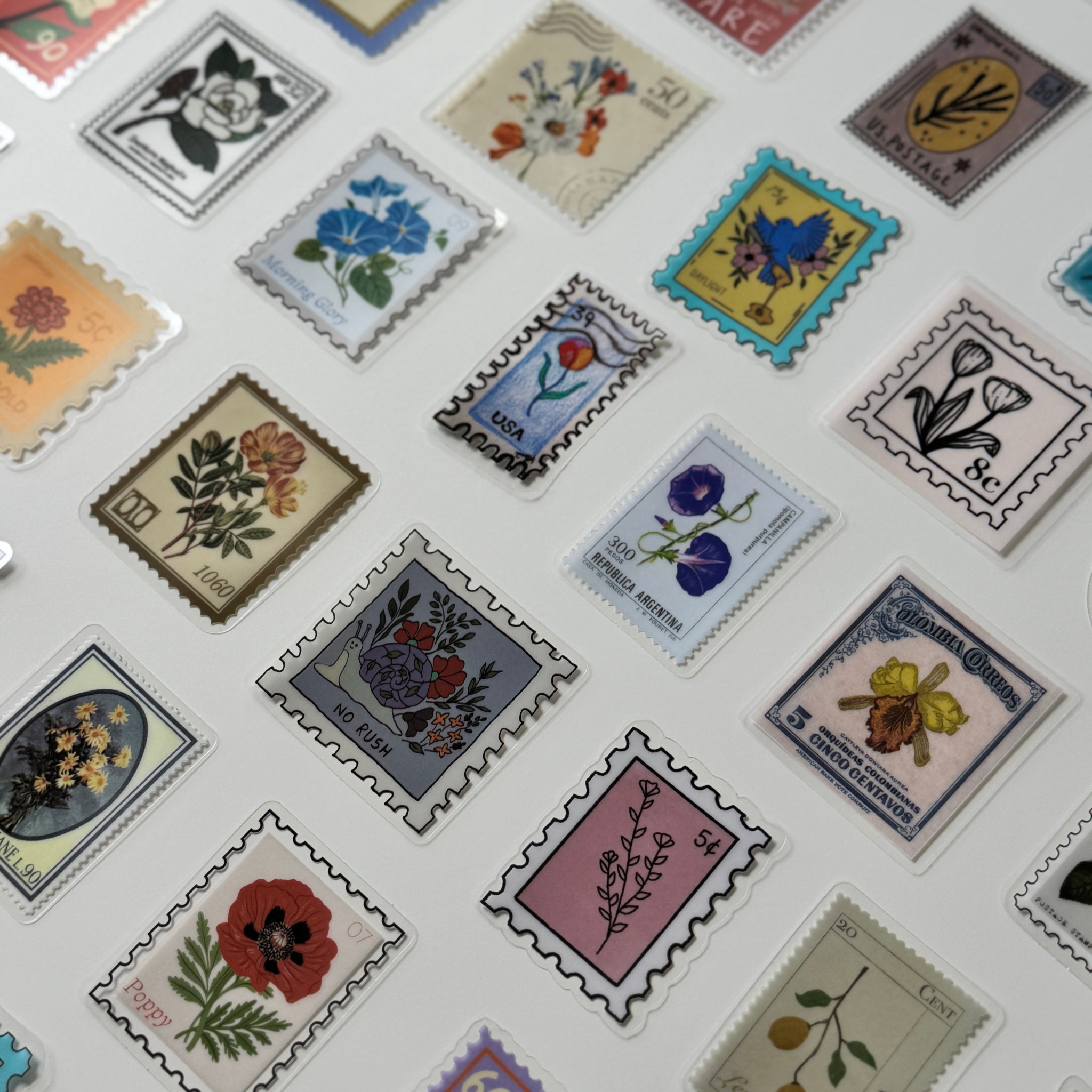 Collection of decorative stamps with floral and nature-themed designs on a white background.