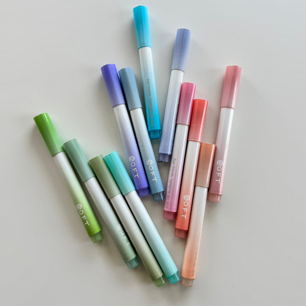 Set of colorful markers on a light gray background