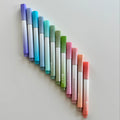 Set of gradient-colored markers arranged in a fan-like pattern on a light gray background.