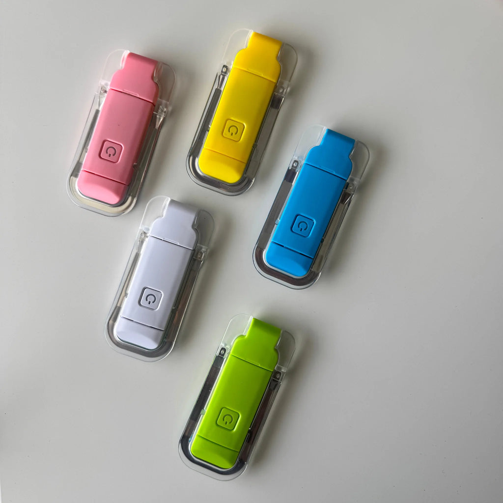 Five colorful USB reading light in clear cases on a light gray background