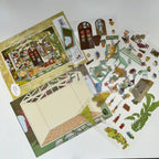 Set of miniature paper buildings and figures on a white background