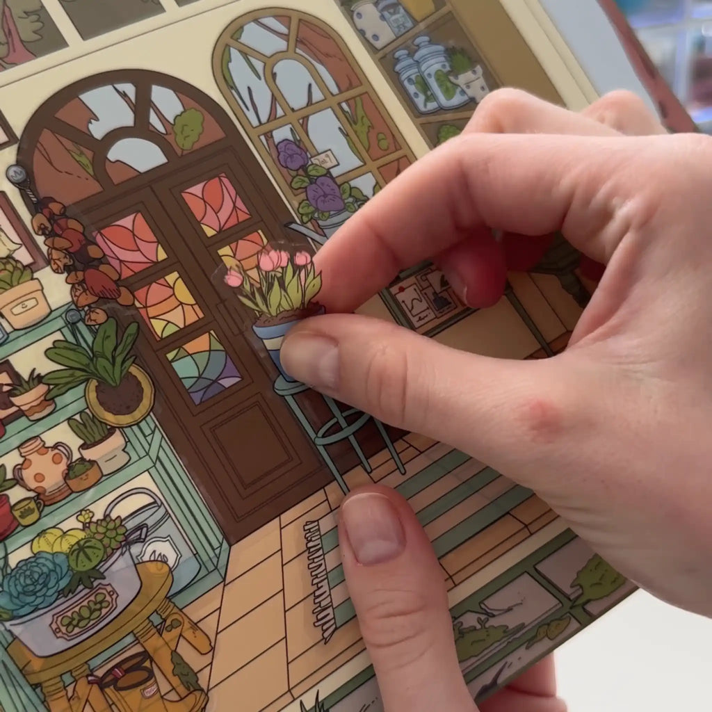 Hand interacting with a colorful illustrated scene on a card