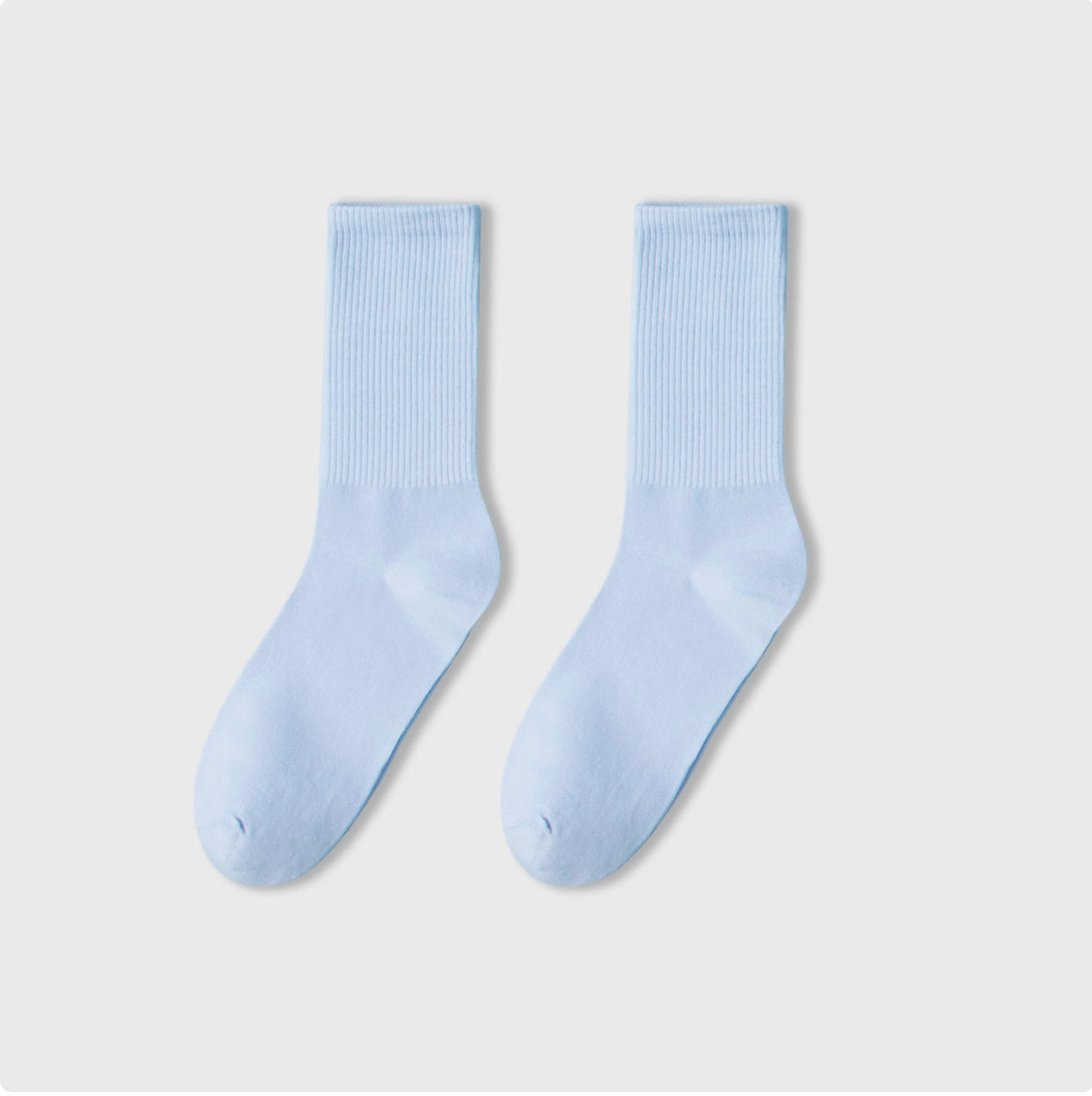 Pair of light blue socks on a white background