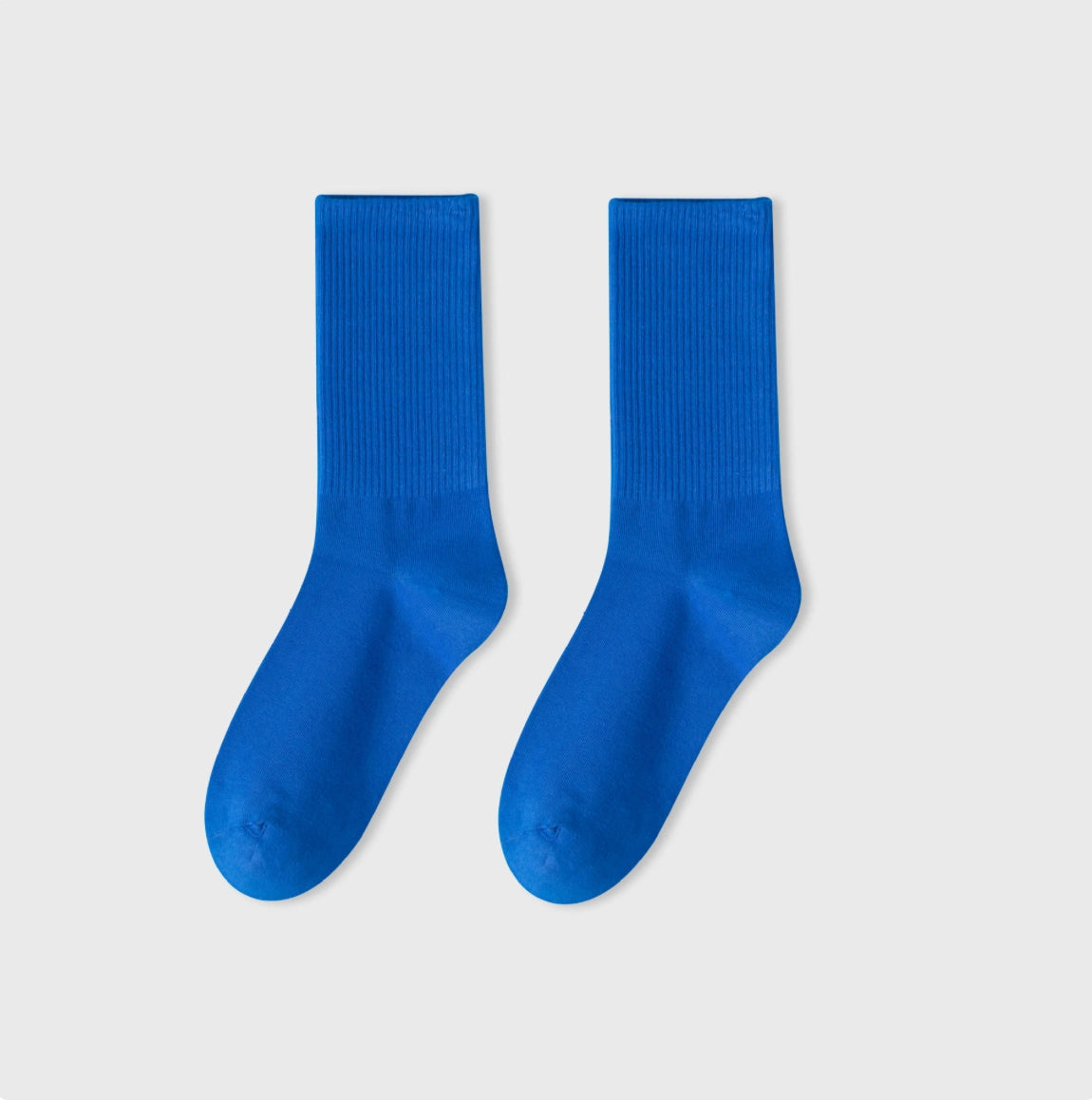 Pair of blue socks on a light gray background