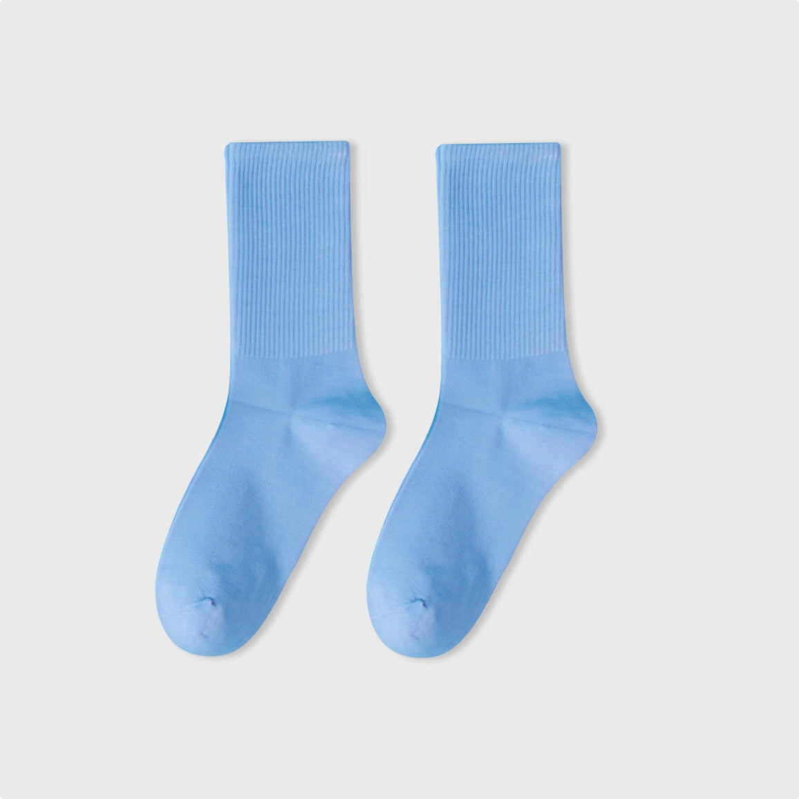 Pair of light blue socks on a white background