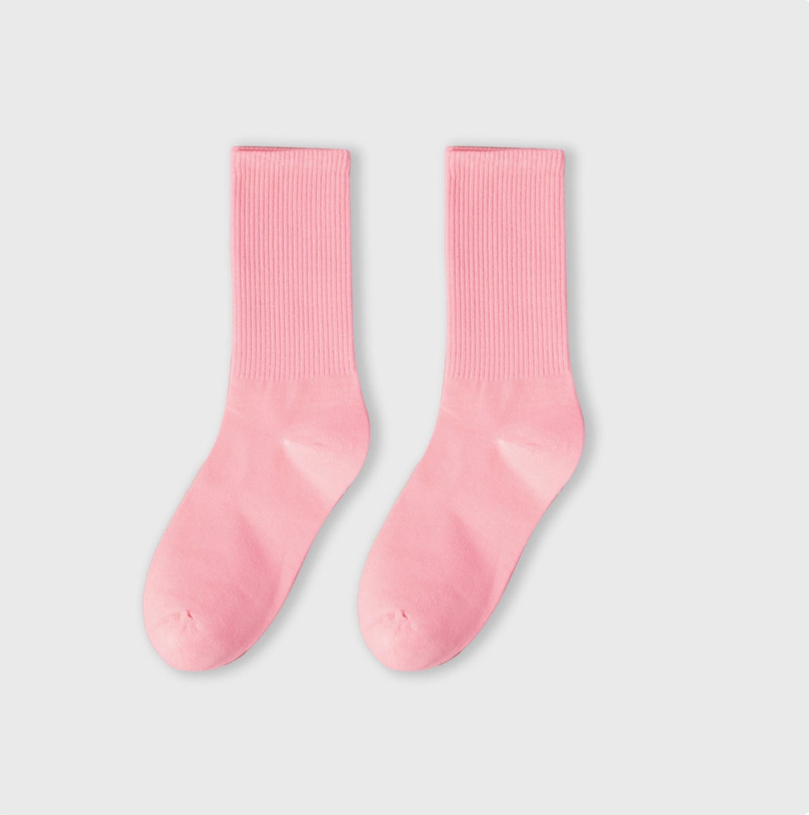 Pair of pink socks on a light gray background