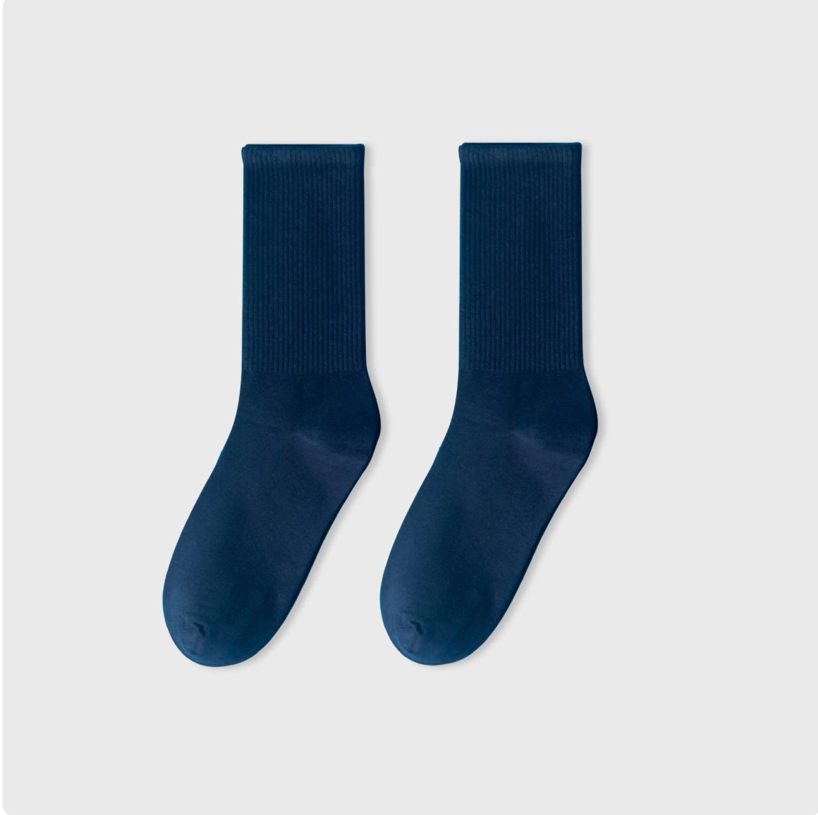 Pair of navy blue socks on a light gray background
