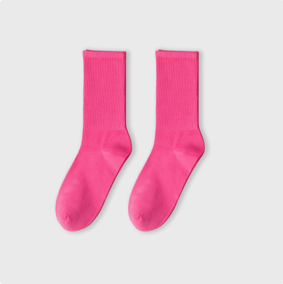 Pair of bright pink socks on a light gray background